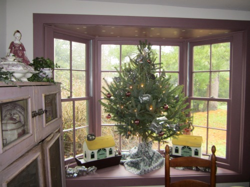A small Christmas tree graces the bay window in our 1840's kitchen.